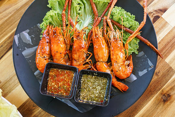 istock Grilled Prawns with Spicy Dipping Sauces on Lettuce Bed 2253670834