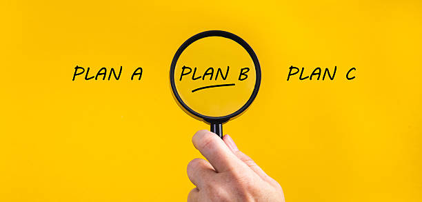 istock Hand holding magnifying glass focusing on plan b 2253670908
