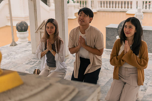 istock Young asian people praying at temple, showing respect and spiritual devotion 2253671738