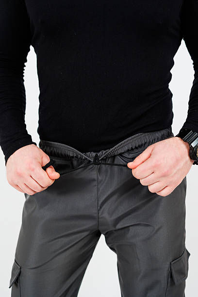 istock A man in a black shirt and pants has hands in pockets 2253671743