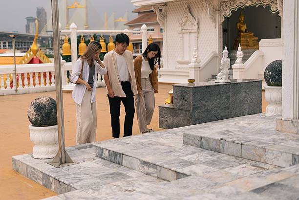 istock Young asian tourists exploring an ancient buddhist temple in thailand 2253672973