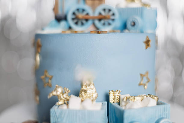 This whimsical blue train cake, beautifully adorned with shiny gold stars and adorable mini gifts, is truly perfect for celebrating a childs birthday or any festive occasion