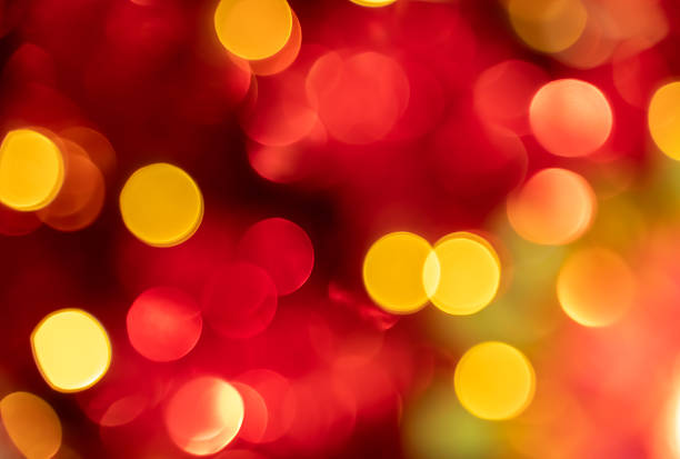 Soft red and yellow bokeh abstract background with glowing light circles and warm festive blur