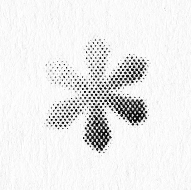 Minimal black snowflake made from halftone dots on white textured paper. Simple winter holiday symbol with lots of negative space and a vintage print feel.