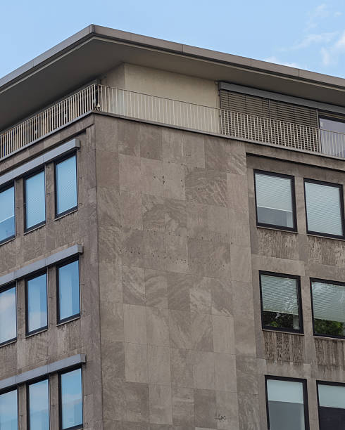 istock Modern building facade with large windows and rooftop balcony in an urban setting 2253682749