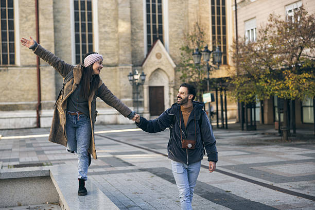 istock Tourist Couple Holding Hands And Walking 2253683181
