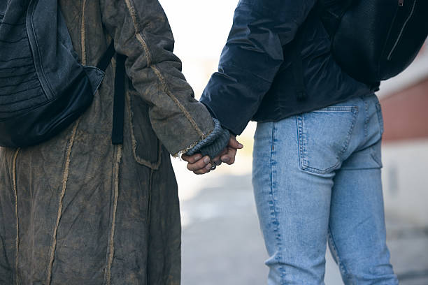 istock Close Up Of Two People Holding Hands 2253683304