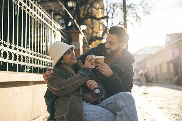 istock Couple Enjoying Coffee Together On A  Bench 2253683482