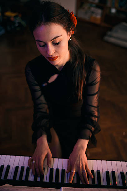 istock Beautiful Woman Playing Piano 2253685394