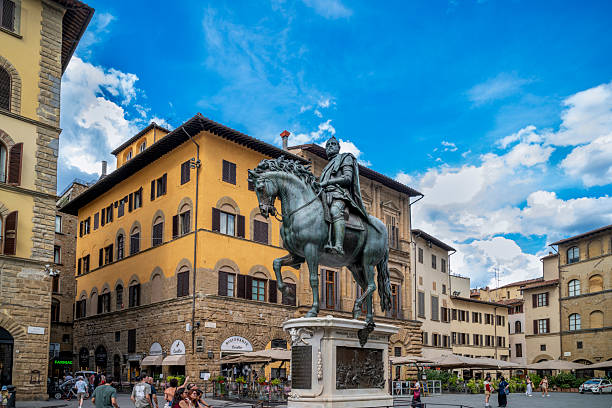 24 July 2025 Florence, Italy. Equestrian monument of Cosimo I de’ Medici dominating Piazza della Signoria, surrounded by historic palaces, cafés, and lively urban life under a dramatic blue sky, showcasing Renaissance heritage in Florence, Italy.