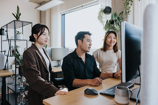 istock Team collaborates at a modern office desk 2253686695
