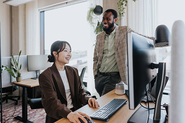 istock Diverse coworkers collaborate at a modern office desk 2253686705