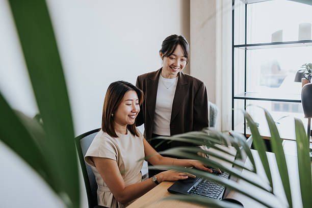istock Colleagues collaborate at a laptop in a modern office 2253686738