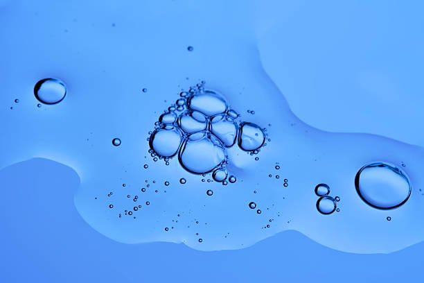 istock The texture of a cosmetic serum with bubbles on a blue background. 2253688455