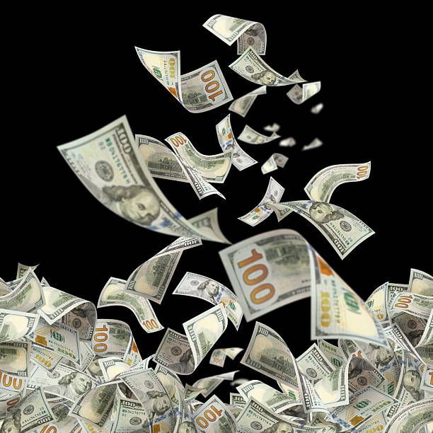 istock Flying hundred dollar bills, isolated on black background 2253689185