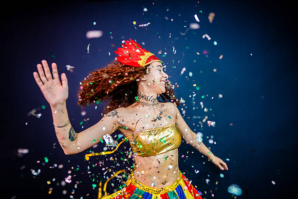 Happy young woman dancing and enjoying Carnaval - Studio Shot