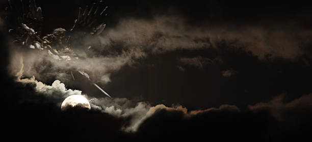 istock Saint Michael silhoutted by a full moon in clouds 2253695651