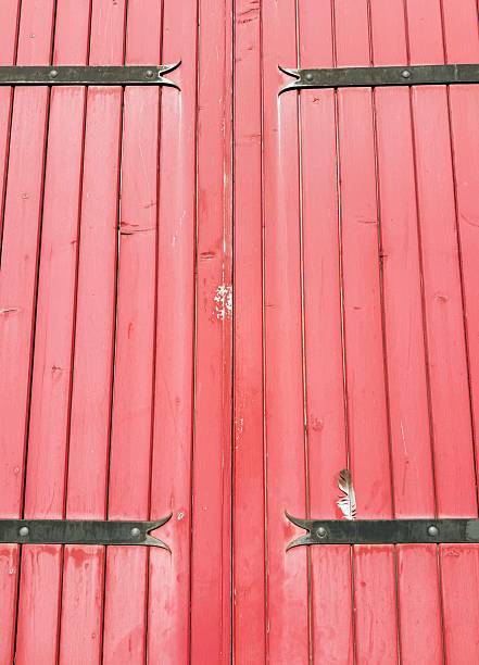 istock Old red wooden doors with metal accents 2253698150