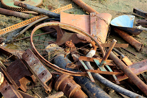 Rusty Cogwheel Gear with Barbed Wire on Industrial Scrap Ground