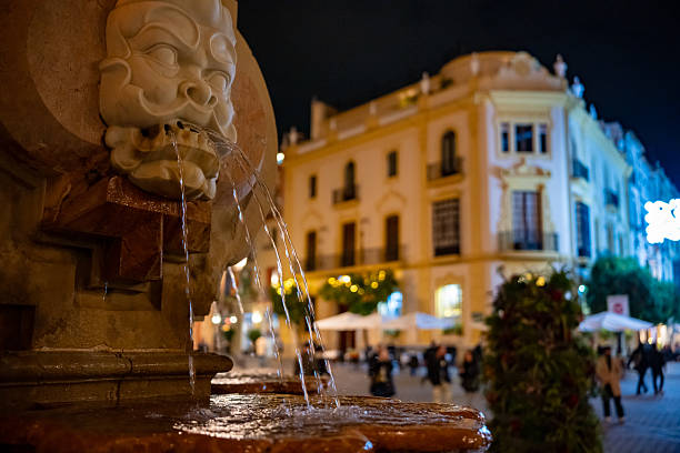 Vibrant Mediterranean Nightfall: Crowds Enjoying the Historic Streets, Tapas Culture, and Illuminated Landmarks of Downtown Seville, Andalusia, Spain