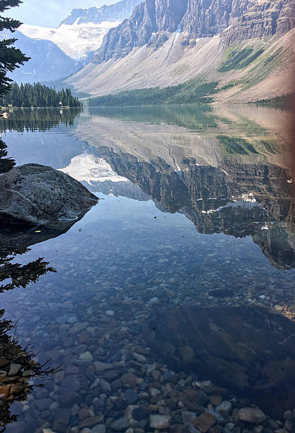 istock Scenic alpine lake surrounded by evergreen trees and steep mountain slopes. 2253699954