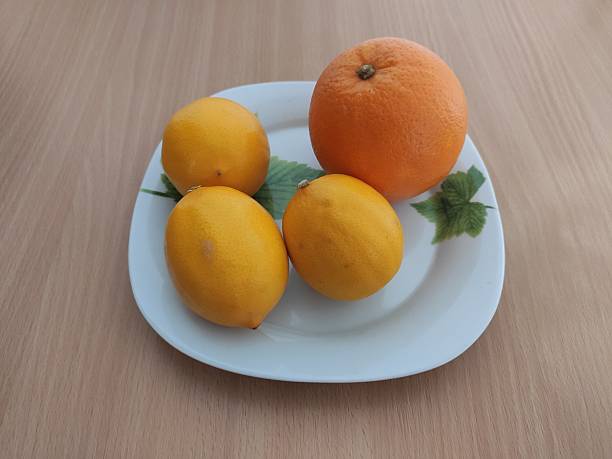 istock Fresh oranges and yellow lemons on the wooden table 2253701147