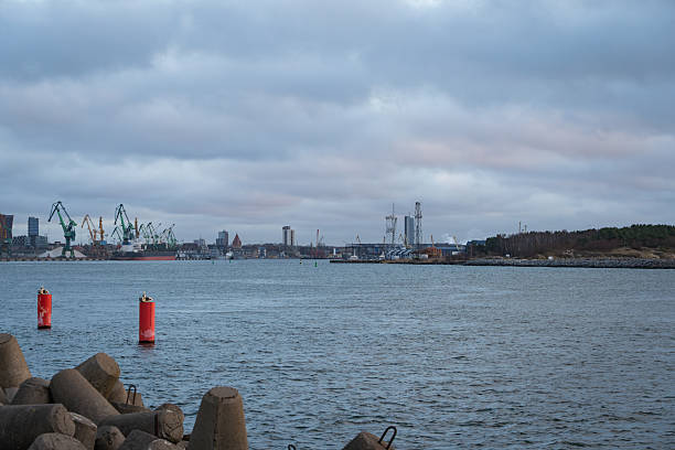 istock Industrial harbor with concrete breakwaters and cranes 2253701155