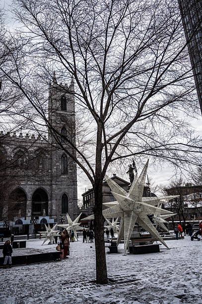 Montreal Notre-Dame Cathedral with christmas decoration in public park in front during a winter day