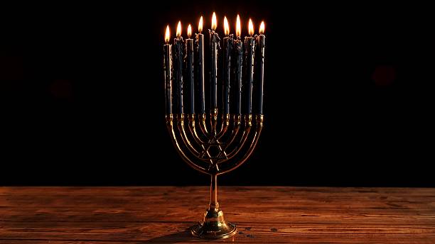 istock Elegant Bronze Menorah Adorned With Glowing Candles Celebrating Hanukkah Traditions 2253704111