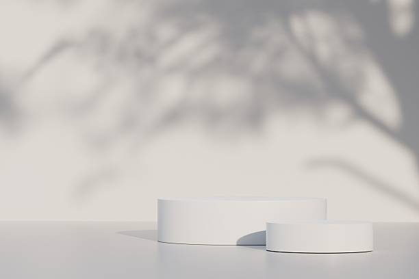 istock Minimal abstract luxury white podiums block for product presentation with empty stage for nature, organic, spa, health, cosmetic, beauty, Sunshade shadow on beige and shadows of tree leaves 3d render. 2253706376