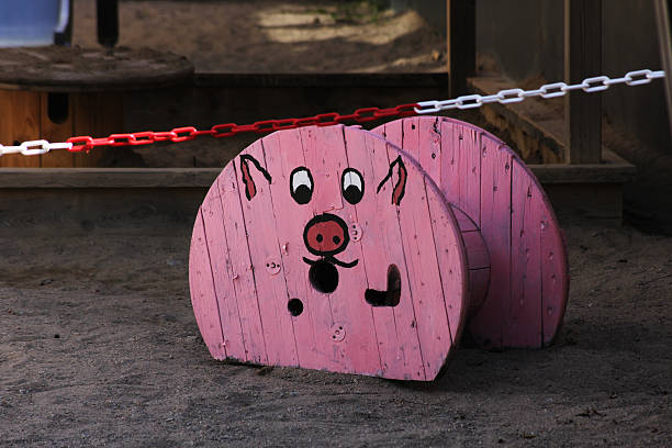 Pink pig bank navigating a wooden maze