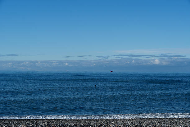 Serene Blue Sea and Clear Blue Sky Horizon: Minimal Nature Background with Ample Copy Space