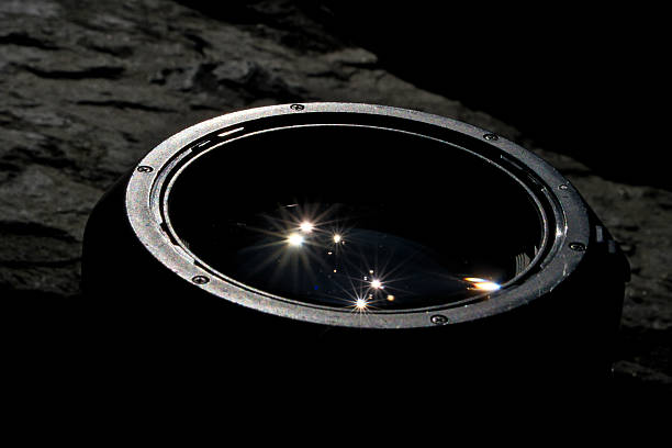 istock Sun Reflection in Pro Camera Lens with Flare on Black Stone Background 2253714156