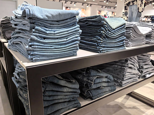 istock Neatly stacked denim jeans in a modern retail store setting 2253726805