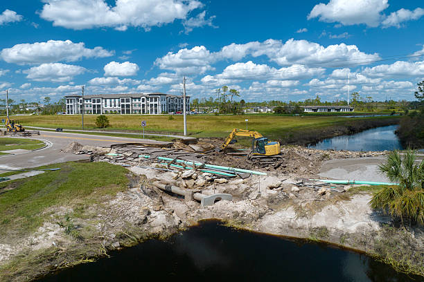 istock Destroyed bridge after hurricane flooding in Florida. Construction equipment at roadwork site. Reconstruction of damaged road after flood water washed away asphalt 2253727243
