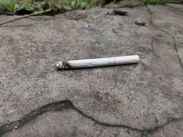 istock close up of a cigarette butt thrown on the floor 2253727818