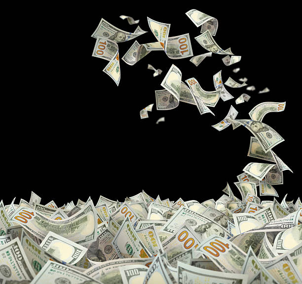 istock Flying hundred dollar bills, isolated on black background 2253727893