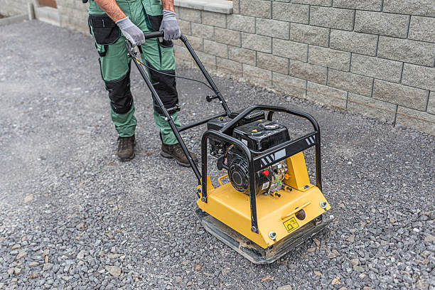 istock Working with vibro-compaction plate to compact gravel  base bed. Vibrating plate in construction. 2253727925