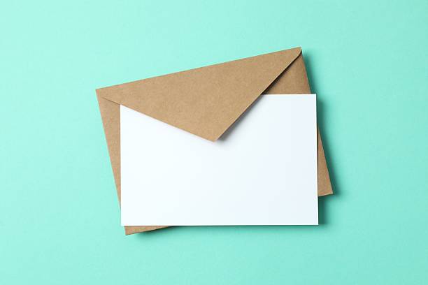istock Paper envelope with white card on color background 2253731381