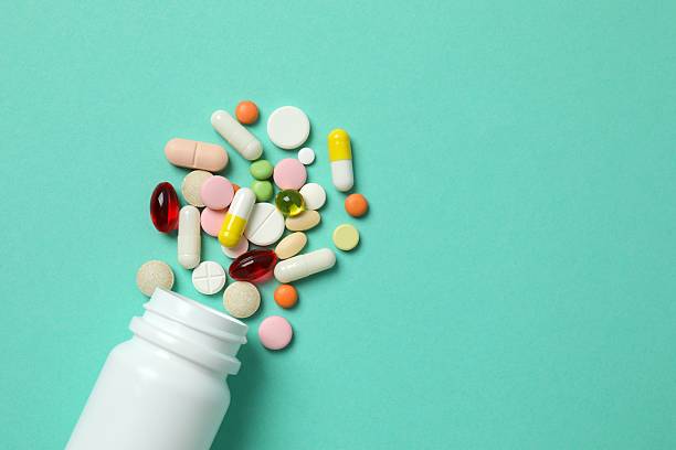 istock Various pills with medicine bottle on color background 2253731436