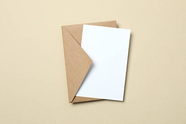 istock Paper envelope with white card on color background 2253731698