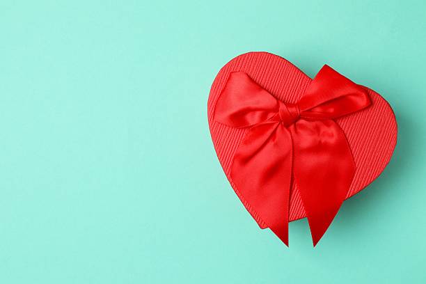 istock Festive gift box with red bow on color background 2253731777