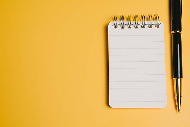 istock Notepad pen blank page spiral notebook writing tool office supply yellow background minimalistic clean stationery creativity 2253731879