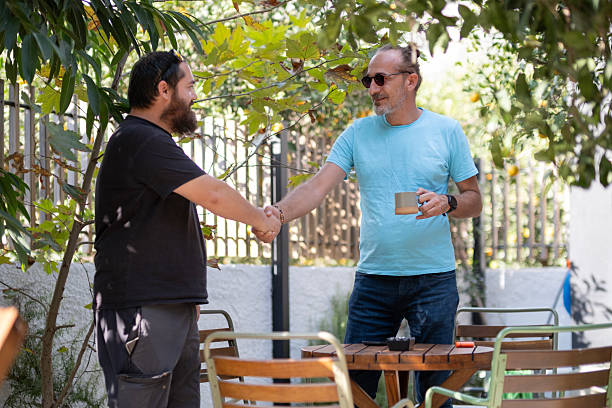 istock Men Relaxing With Coffee or Tea at Outdoor Table. 2253732550
