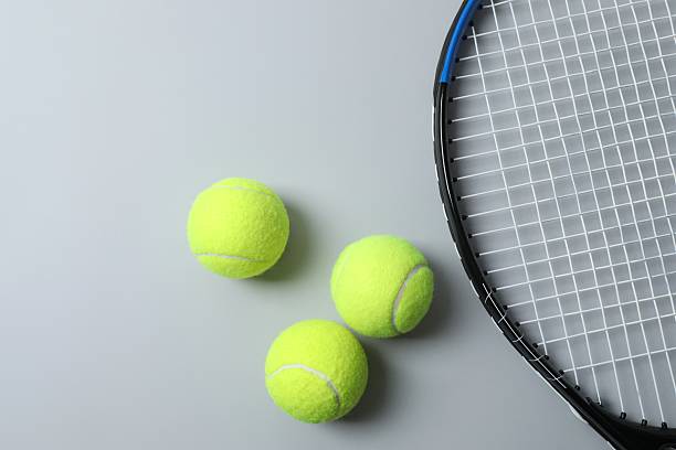 istock Tennis racket and balls on gray background 2253732703