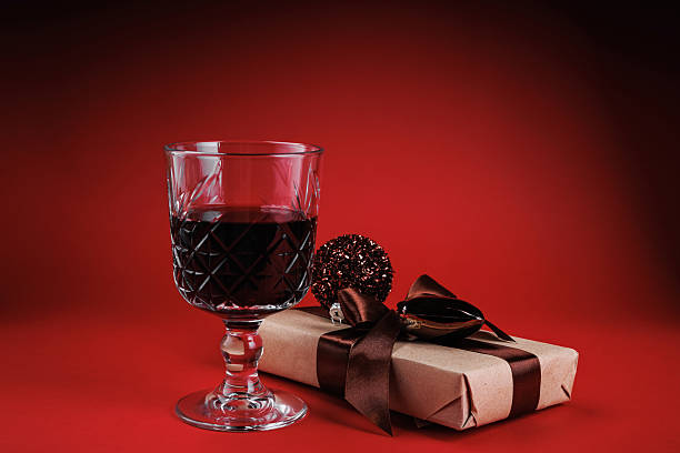 istock Red wine and festive box with brown ribbon 2253732852