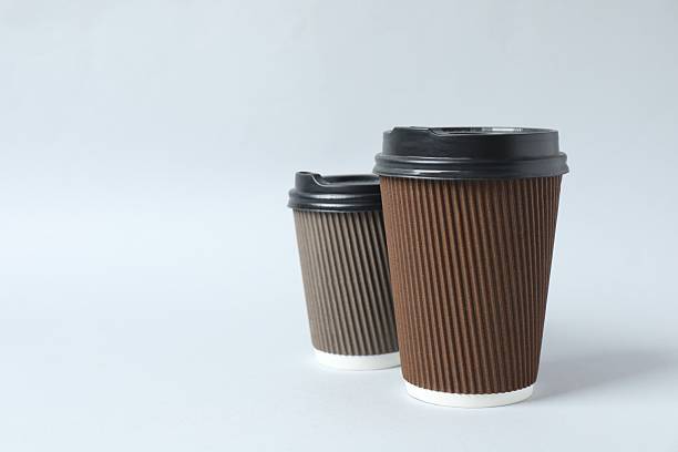istock Paper cups with plastic lid on light background. Coffee to go 2253732861