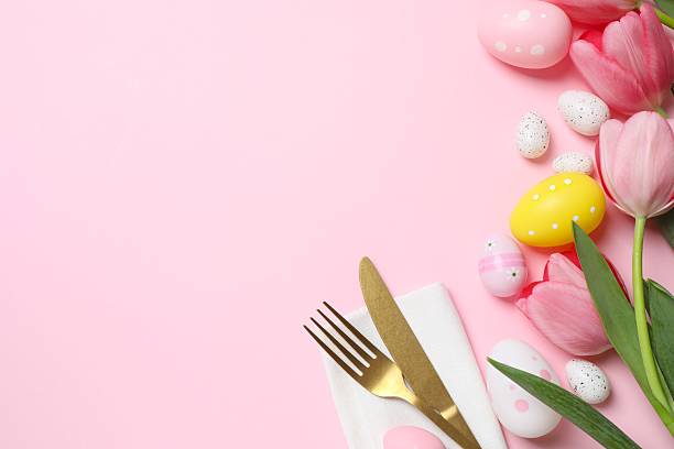 istock Happy Easter. Top photo with cutlery, eggs and tulips on color background with empty space 2253732908