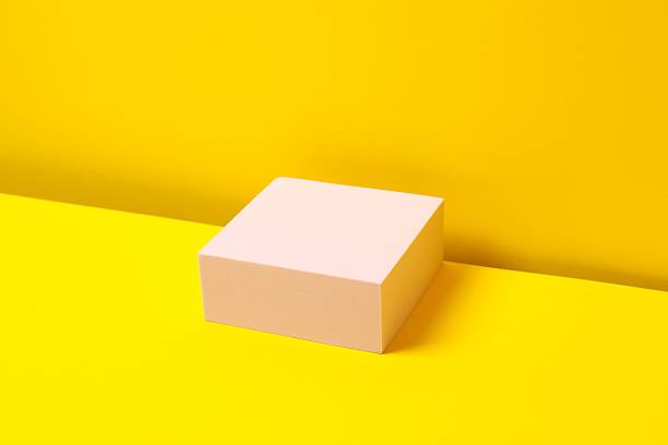 istock Pink podium on a yellow background 2253733136