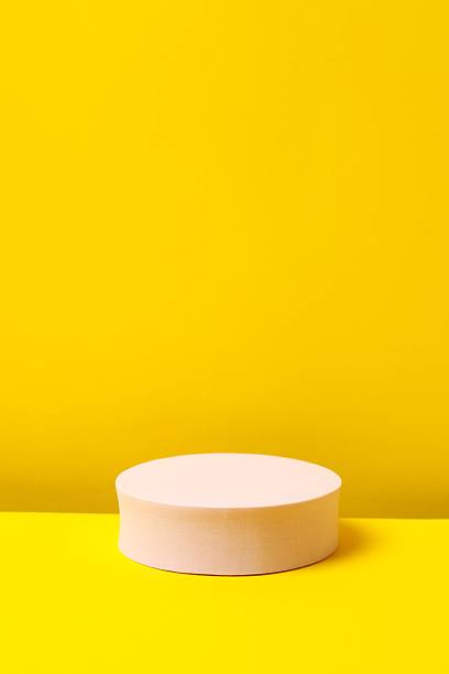 istock Pink podium on a yellow background 2253733137